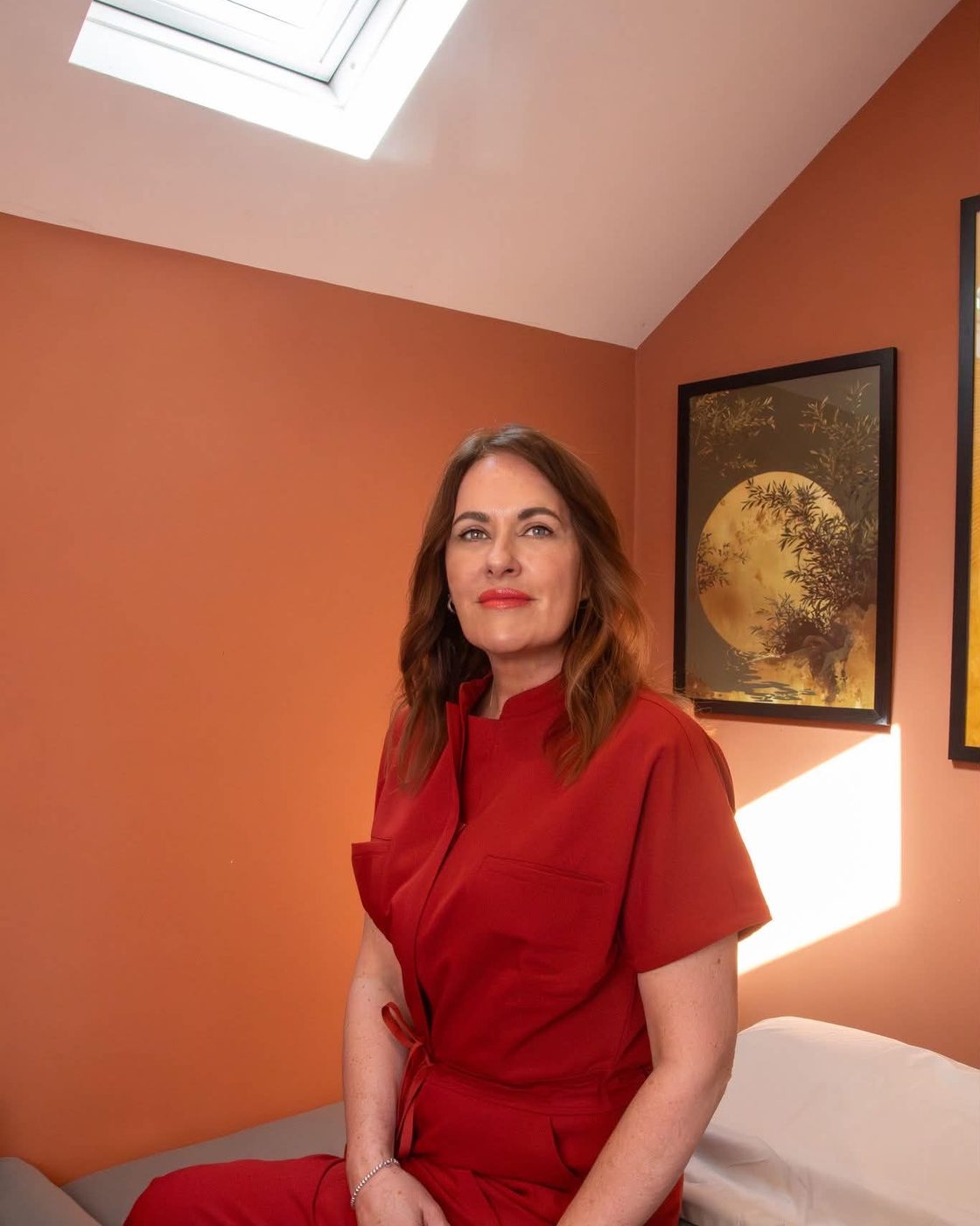 Jayne, founder of Awakened Aesthetics & Coaching, in her treatment studio